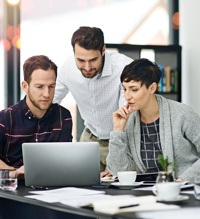 Business, people and meeting in boardroom with laptop for discussion on teamwork, collaboration on project. Office, strategy and ideas in startup company with reviews, report and feedback for growth.
